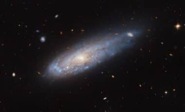 Hubble Captures Dramatic Image Of A Galaxy Racing Through Space, Shaped By Cosmic Forces