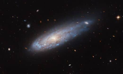 Hubble Captures Dramatic Image Of A Galaxy Racing Through Space, Shaped By Cosmic Forces